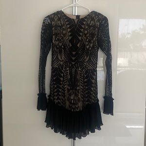 Saints + Secrets black long sleeve ruffle bottom dress